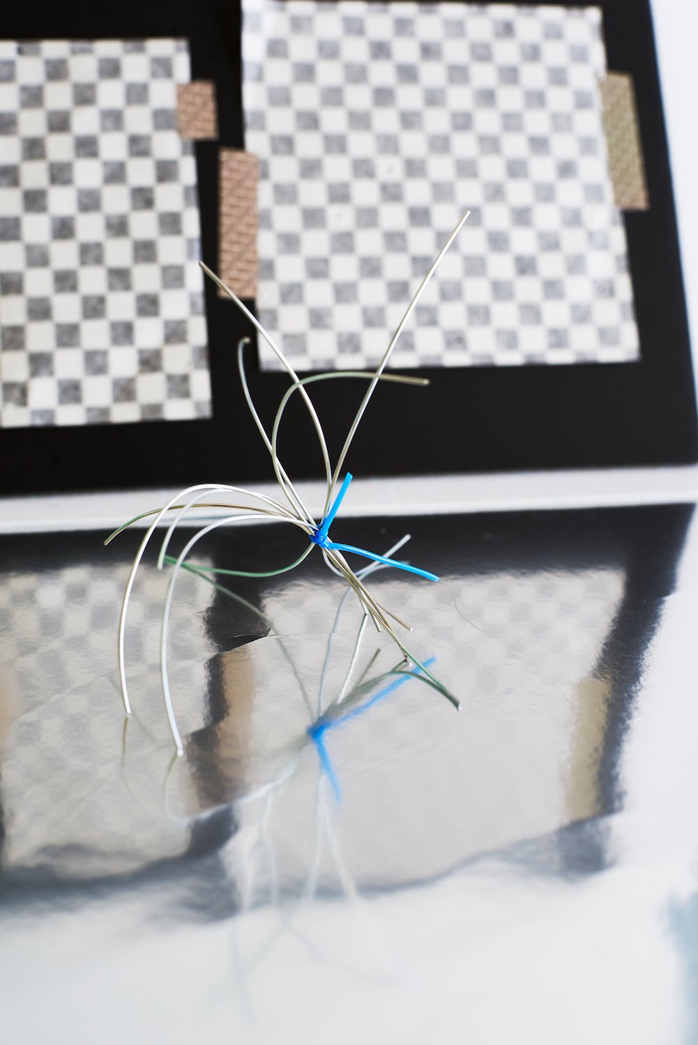 Checkerboard and silver wire form with blue tie, 2023