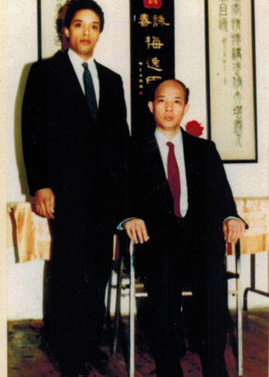 Grandmaster Moy Tung (left) with his Sifu, Grandmaster Moy Yat (seated).