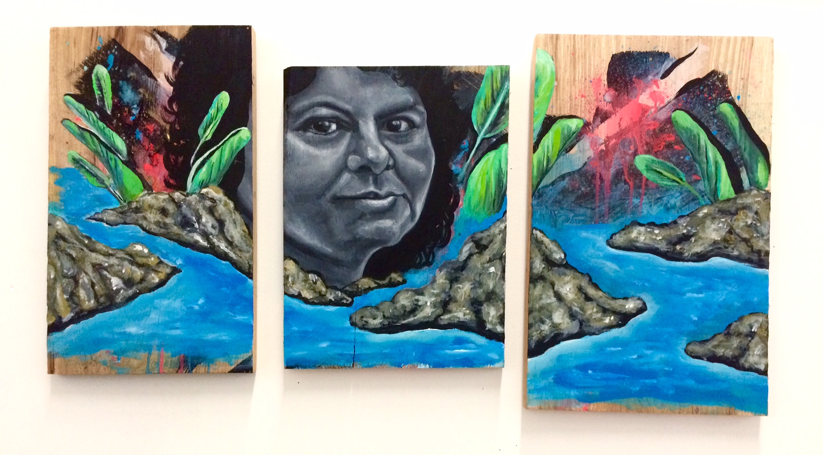 Portrait tribute to Berta Cáceres, late Honduran environmental activist who was assassinated in early March 2016. Her life's work was protecting the Lenca people and their sacred river from corporate exploitation. Her physical body may be gone, but her resolve will never go away. Triptych, acrylic on wood, March 2016.