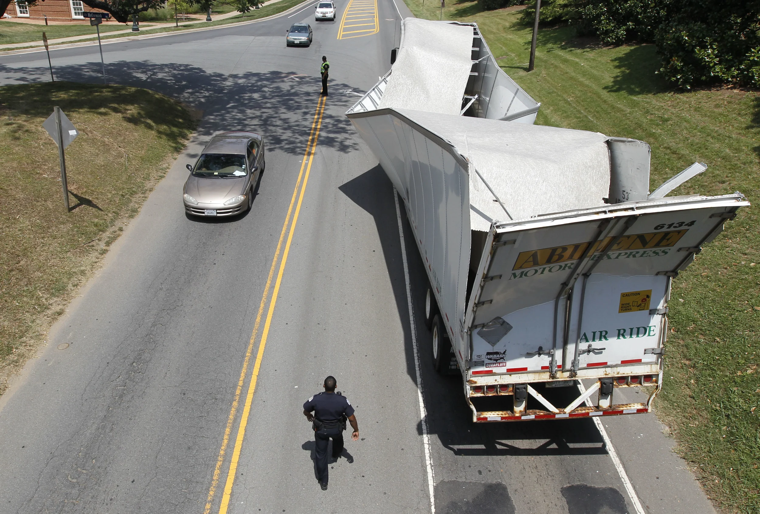 A sand-carrying semi-tractor and trailer struck the McCormick Road bridge over Emmet Street on Thursday, damaging the trailer. The Abilene Motor Express truck, with an estimated height of about 13 feet, 5 inches tall, tried to negotiate the bridge which has a maximum clearance of 12-feet, 5 inches, according to Charlottesville police. The truck was traveling from Illinois to Culpeper, Va. Copyright: The Daily Progress