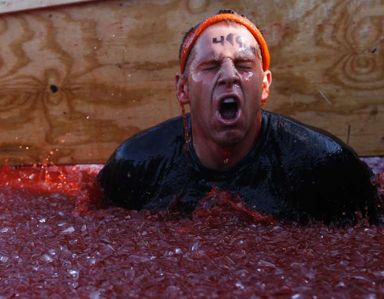  A Tough Mudder emerges from a dumpster filled with ice and water during the obstacle "Chernobyl Jacuzzo" in the Tough Mudder event at Wintergreen Saturday, Oct. 22, 2011.&nbsp; Copyright: The Daily Progress       