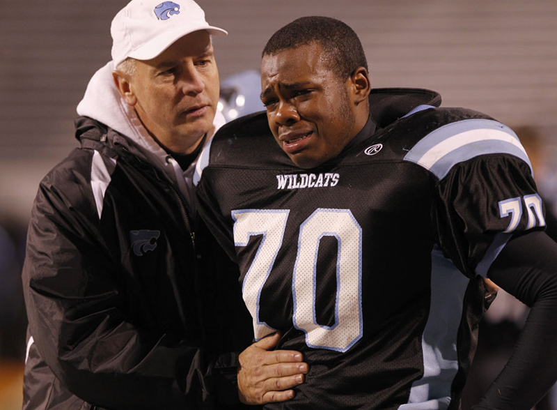  Centreville High School principal Mike Campbell talks with Josh Smith (70) in the second half of the during the Virginia AAA Division 6 high school football final at Scott Stadium Saturday, Dec. 10, 2011. Oscar Smith beat Centreville 47-21. Copyrigh