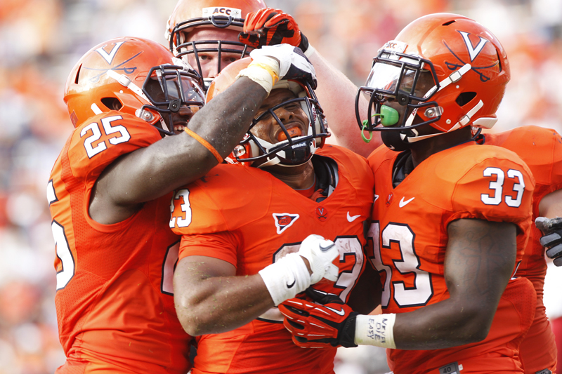  Virginia Cavaliers' Kevin Parks (25) (left) and Perry Jones (33) (right) surround Khalek Shepherd (23) (center) after Shepherd scored a touchdown against the Richmond Spiders at Scott Stadium Saturday, Sept. 1, 2012.&nbsp; Copyright: The Daily Progr