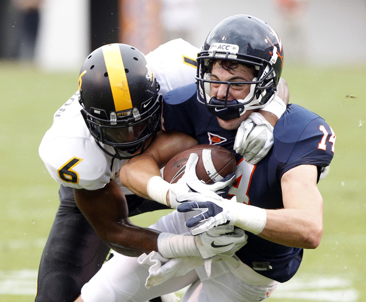  Southern Miss. Golden Eagles defensive back Martez Thompson (6) tackles Virginia Cavaliers wide receiver Matt Snyder (14) during the first half of the game between the Virginia Cavaliers and the Southern Miss. Golden Eagles at Scott Stadium Saturday