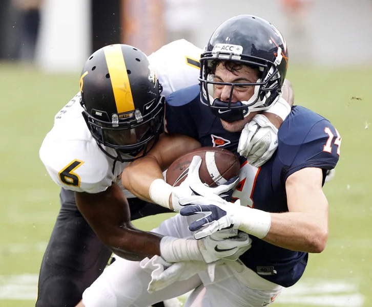Southern Miss. Golden Eagles defensive back Martez Thompson (6) tackles Virginia Cavaliers wide receiver Matt Snyder (14) during the first half of the game between the Virginia Cavaliers and the Southern Miss. Golden Eagles at Scott Stadium Saturday, Sept. 24, 2011. Copyright: The Daily Progress