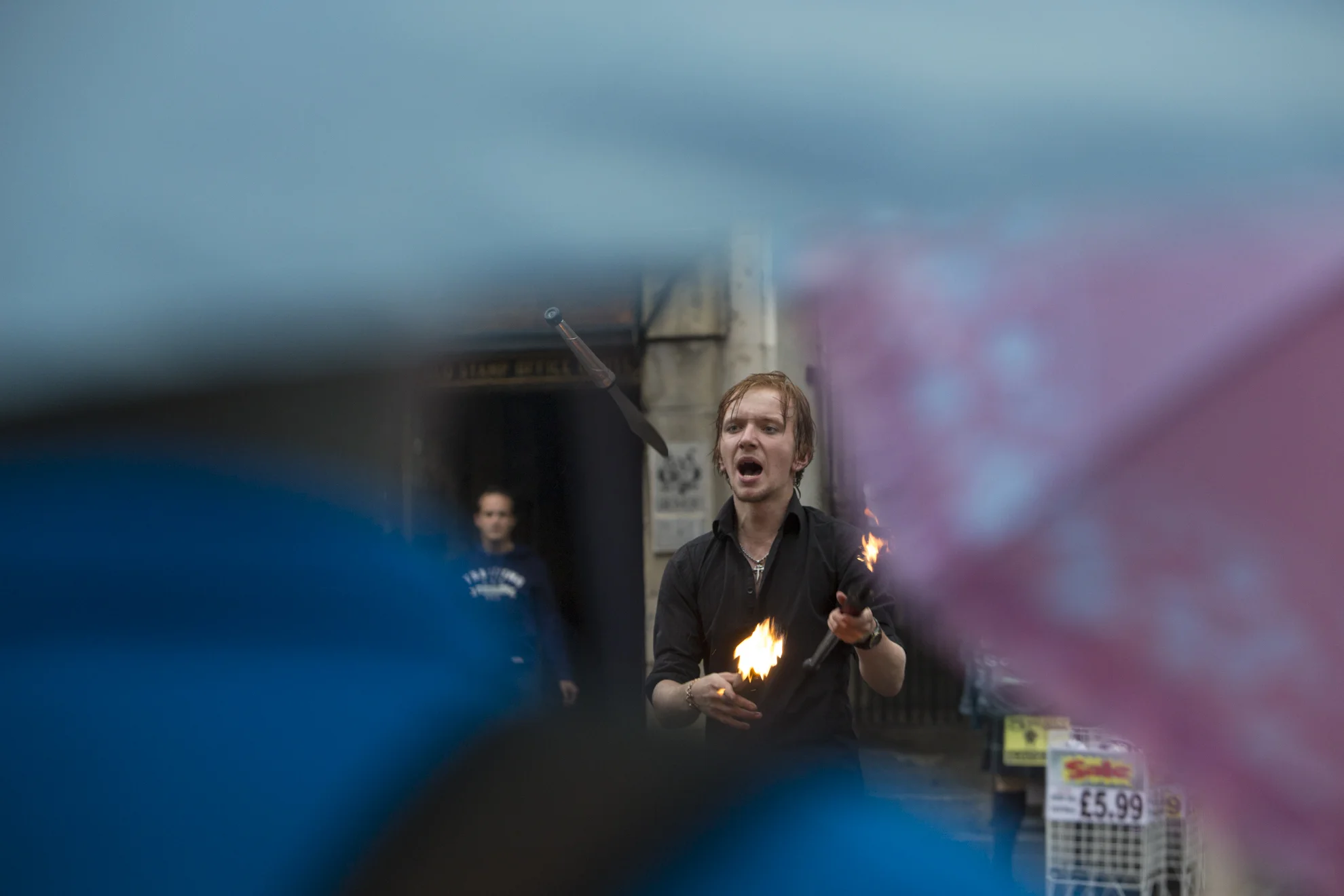 Tommy Everson performs in front of a crowd in the rain during the Edinburgh Festival of the Fringe in Edinburgh, Scotland.