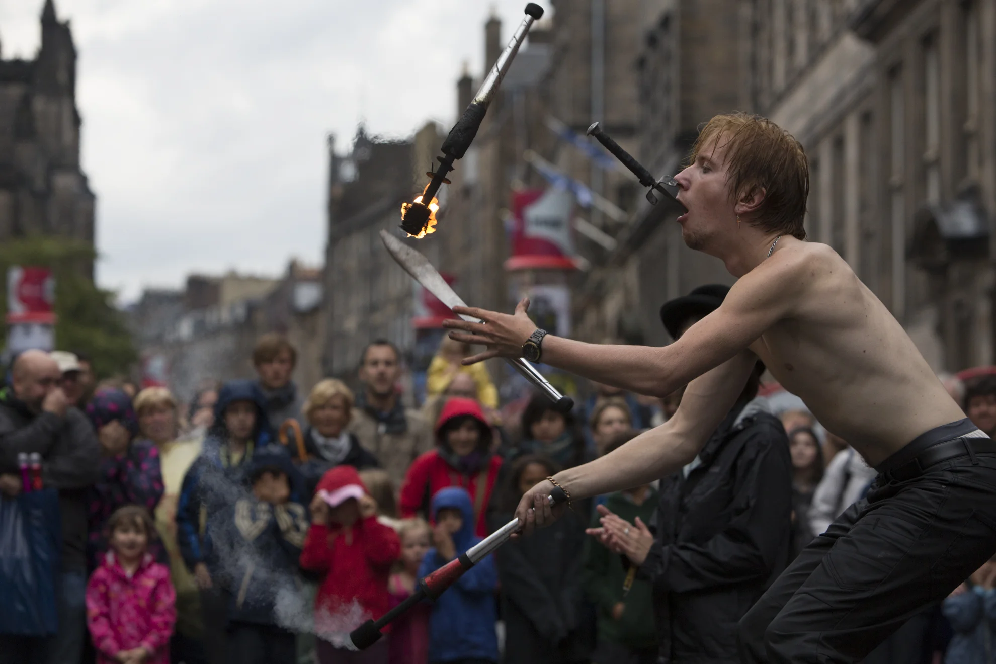 Tommy Everson performs in front of a crowd in the rain during the 2014 Edinburgh Festival of the Fringe in Edinburgh, Scotland.