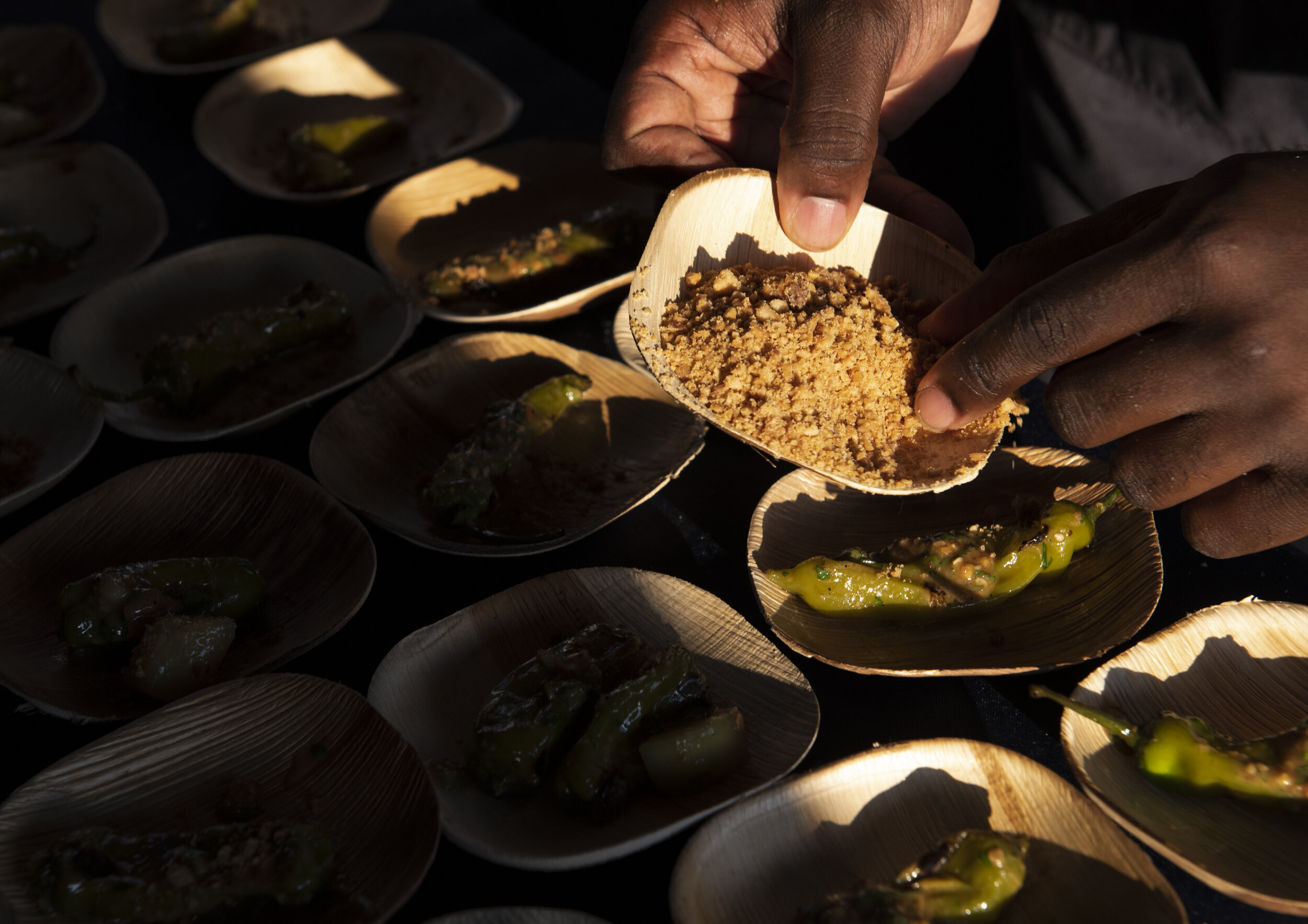  Christian Hunter, from Sorghum &amp; Salt in Charleston, S.C., makes charred shishitos during the euphoria event, "Taste of the South" held at Fluor Field Friday, Sept 20, 2019. (The Greenville News) 