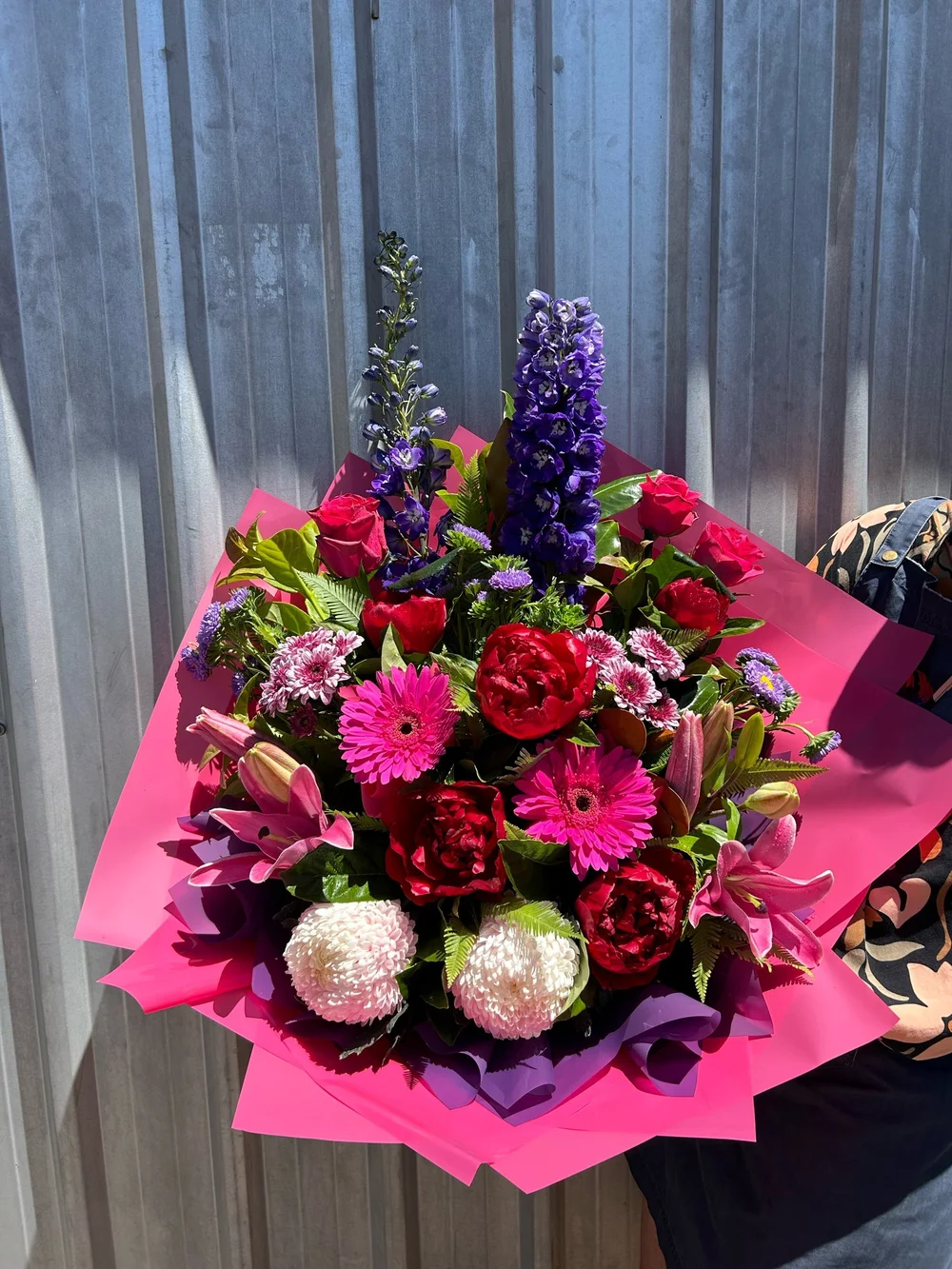 A pink and red wrapped bouquet