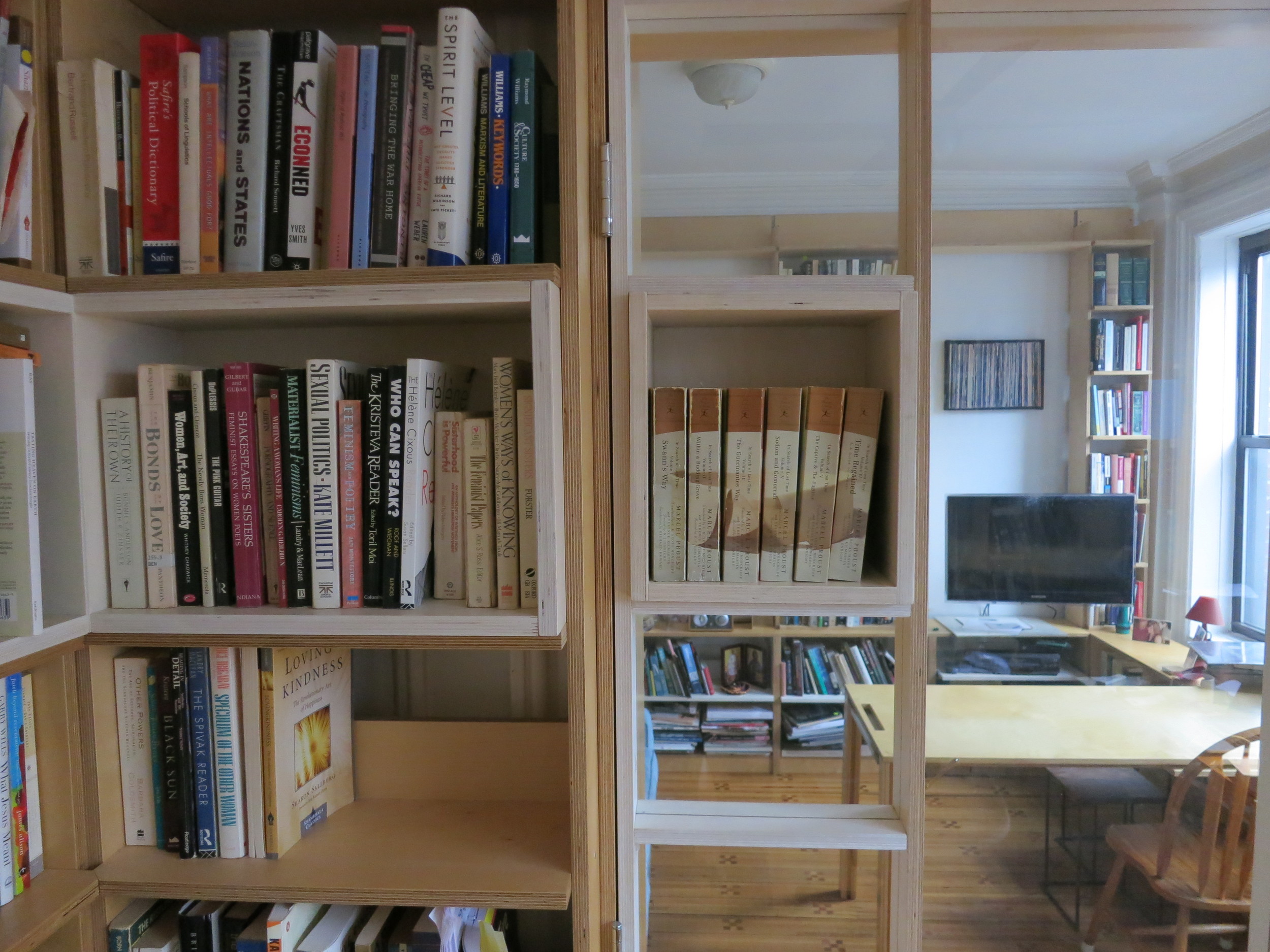 The moment of enjambment is the shelf's continuation past the frame of the door. Rakatansky's design employed the use of color (the white wood) to emphasize this breaking of the design's rhythmic frame.