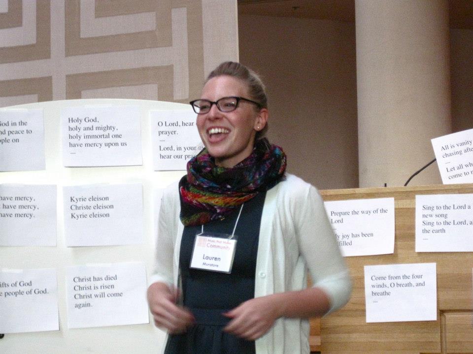 A workshop participant improvises a melody using a text such as those seen behind her.