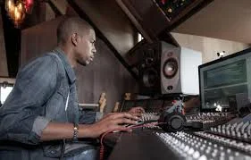 Producer/engineer Young Guru, mulling tradeoffs at the mixing console. Image via massappeal.com .