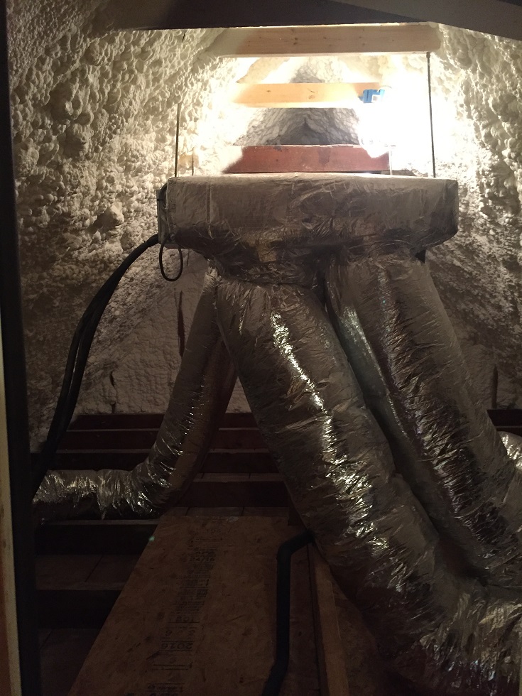  This shot of the attic shows the spray foam insulation and the air handler for the Mitsubishi mini split HVAC system serving the master suite 