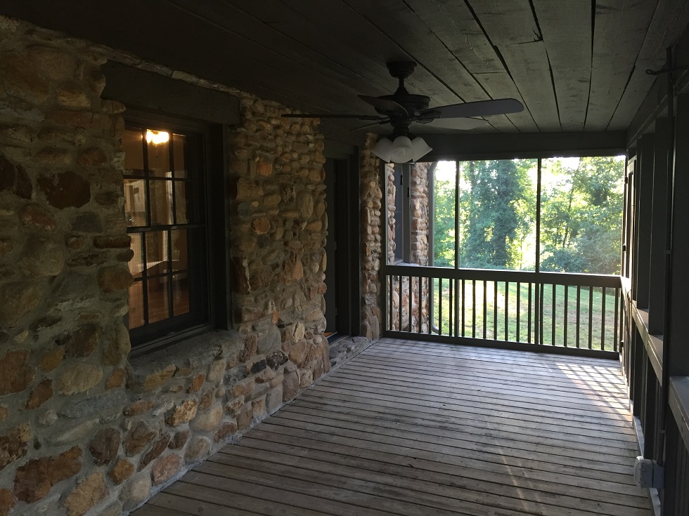   The screen porch was rehabbed to show off the original rough cut pine ceilings  