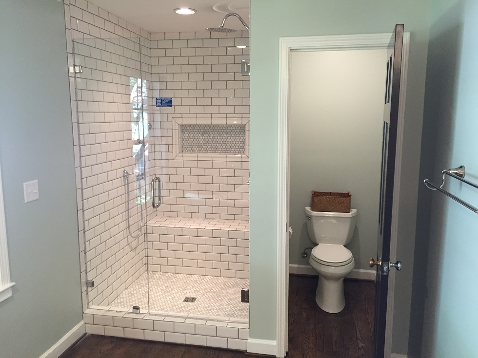  The master bath has a tile shower with a frameless glass door 