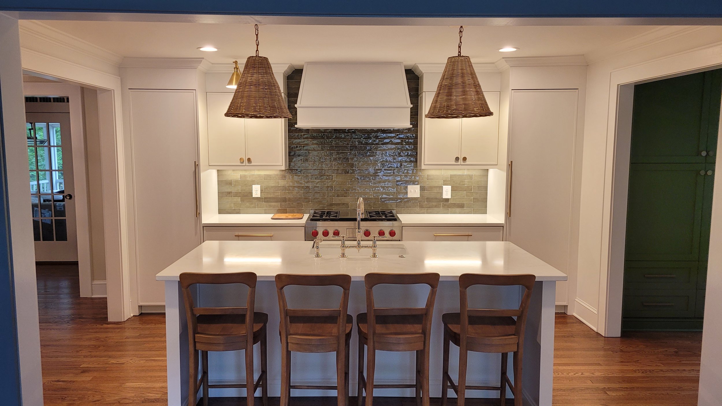  New kitchen with paneled refrigerator and freezer units flanking the new gas range 