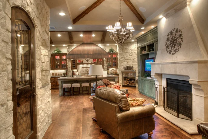 Traditional Traditional rustic kitchen features stained cabinets, glass door fronts, contrasting oversized island and customized vent for stunning results. Project location: Houston, TX