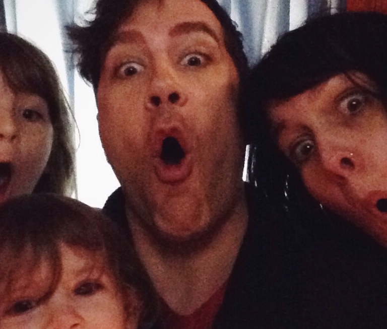 One of our family playful moments. In a Photo Booth that wasn't working. So we used my phone to take a picture. 