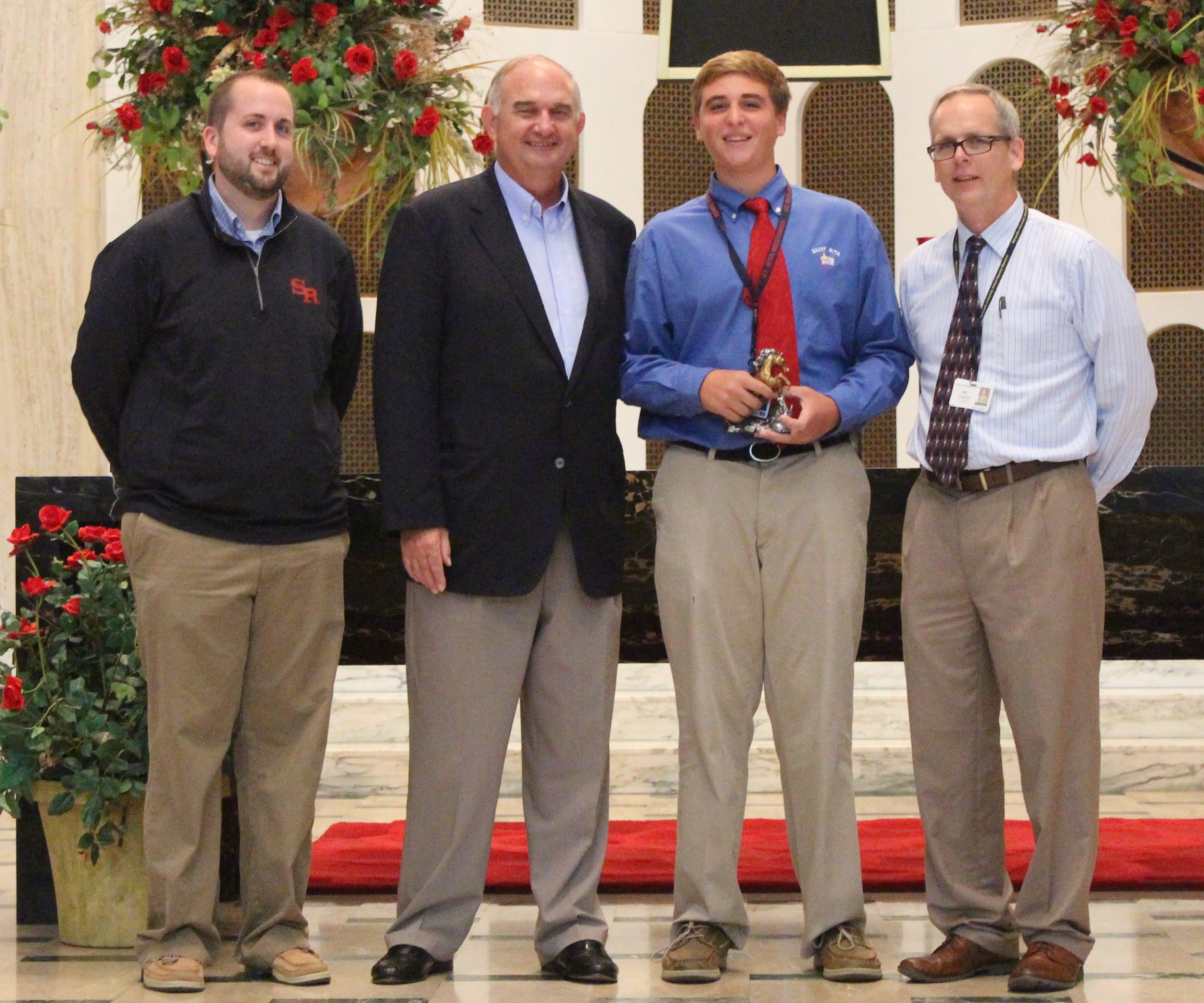 L to R: Josh Blaszak '04, Director of Student Life & Ministry; Ernie Mrozek '71, President; TJ DeCesare, Junior Mustang of the Month; Brendan Conroy, Principal