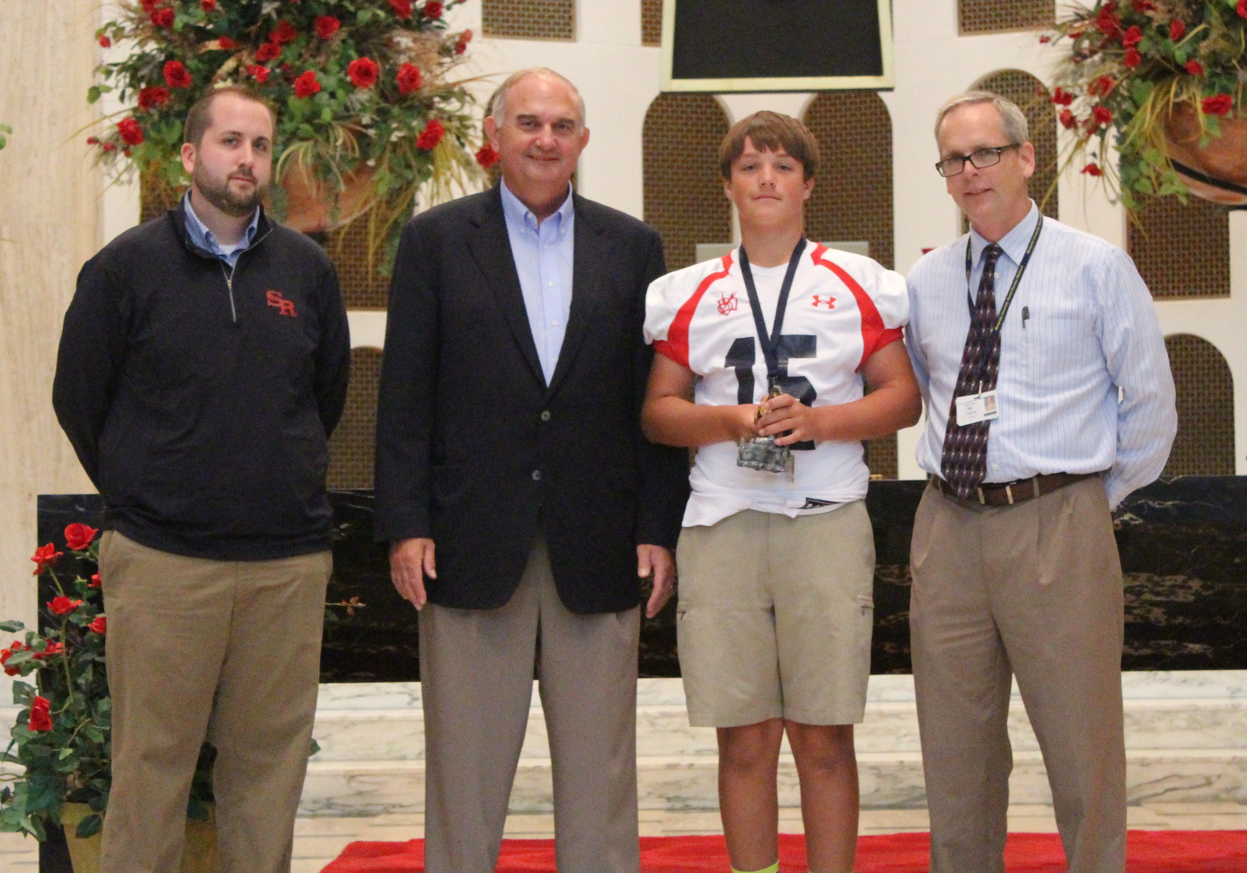 L to R: Josh Blaszak '04, Director of Student Life & Ministry; Ernie Mrozek '71, President; Gavin Mottl, Freshman Mustang of the Month; Brendan Conroy, Principal Gavin Mottl - Freshman Mustang of the Month