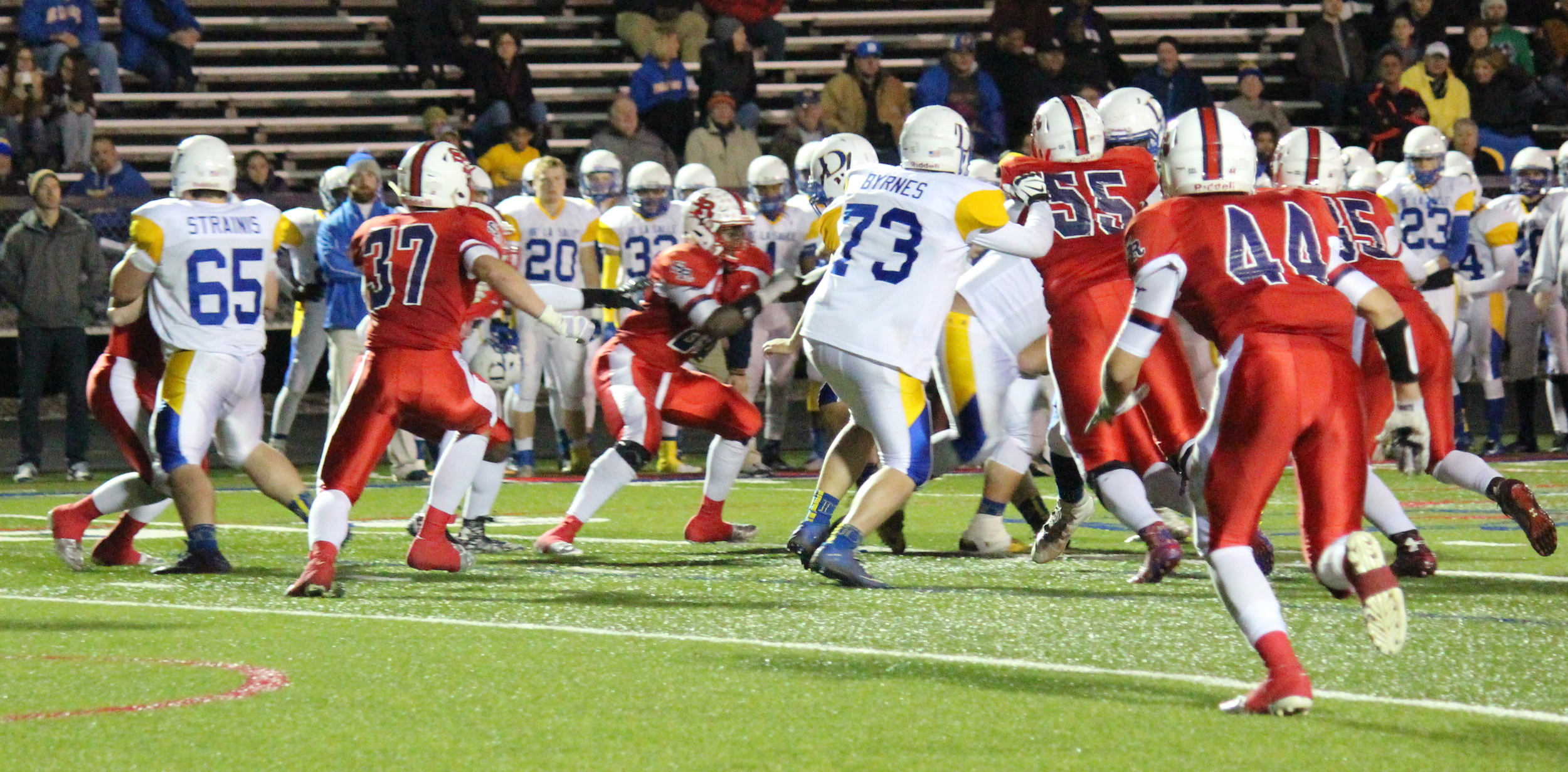 St. Rita defense stepping up to stop the De La Salle attack. Senior Mike Tiernan (#37 St. Catherine of Alexandria), senior Thomas Stacker (#55 Lansing Christian School) and junior Liam Kelly (#44 St. Cajetan)