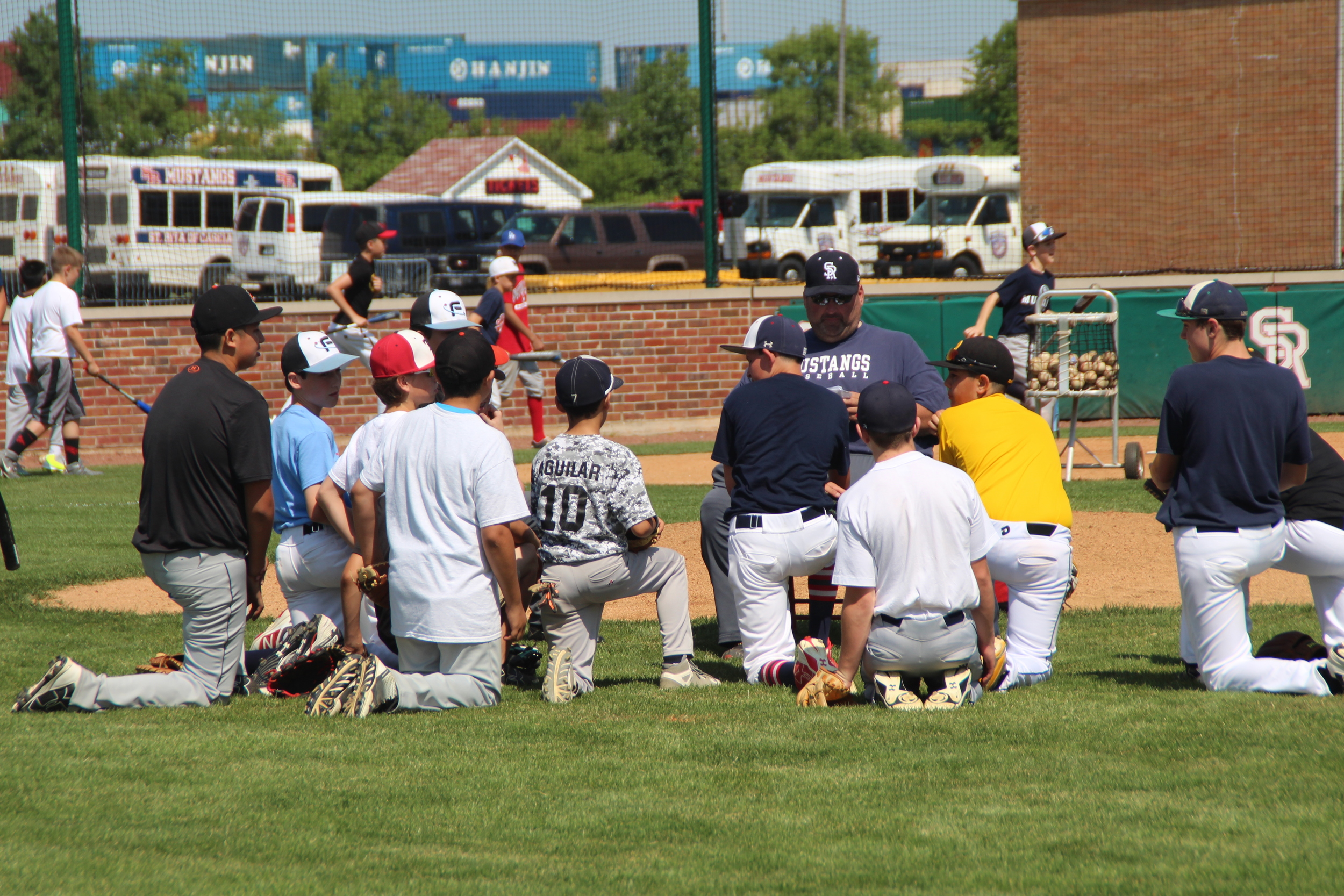 Coach John Nee' 93 talks to the baseball campers