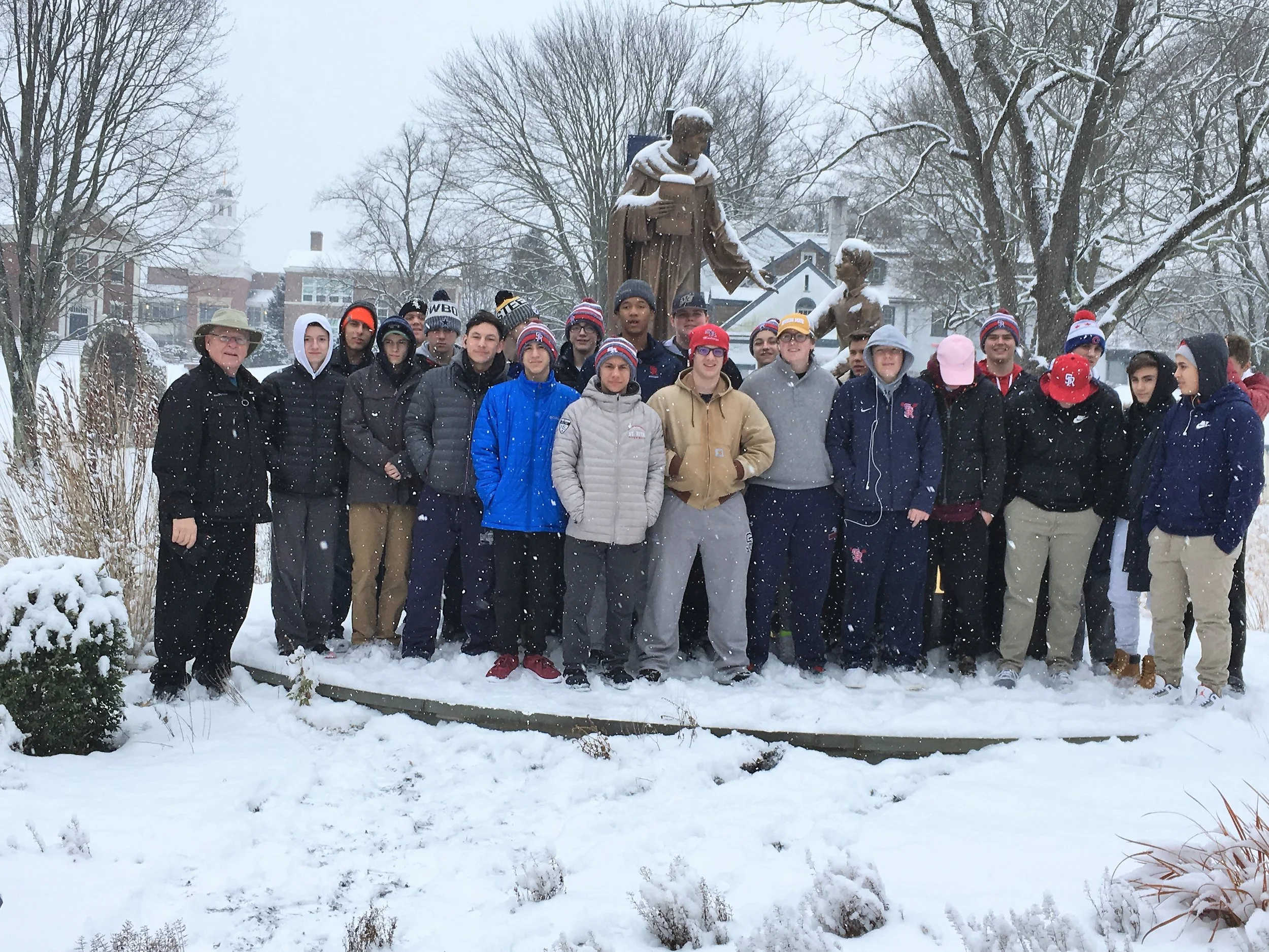 The students visit Malvern Prep outside of Philadelphia during a snow storm. The students are pictured with Fr. Donald Reilly, OSA, Head of School.