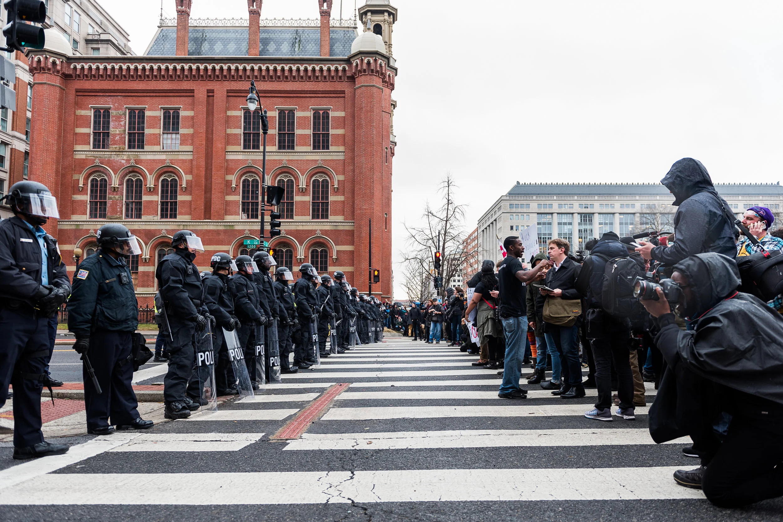 Police officers dressed in riot gear block K Street during a standoff with protesters, Friday, January 20, 2017.