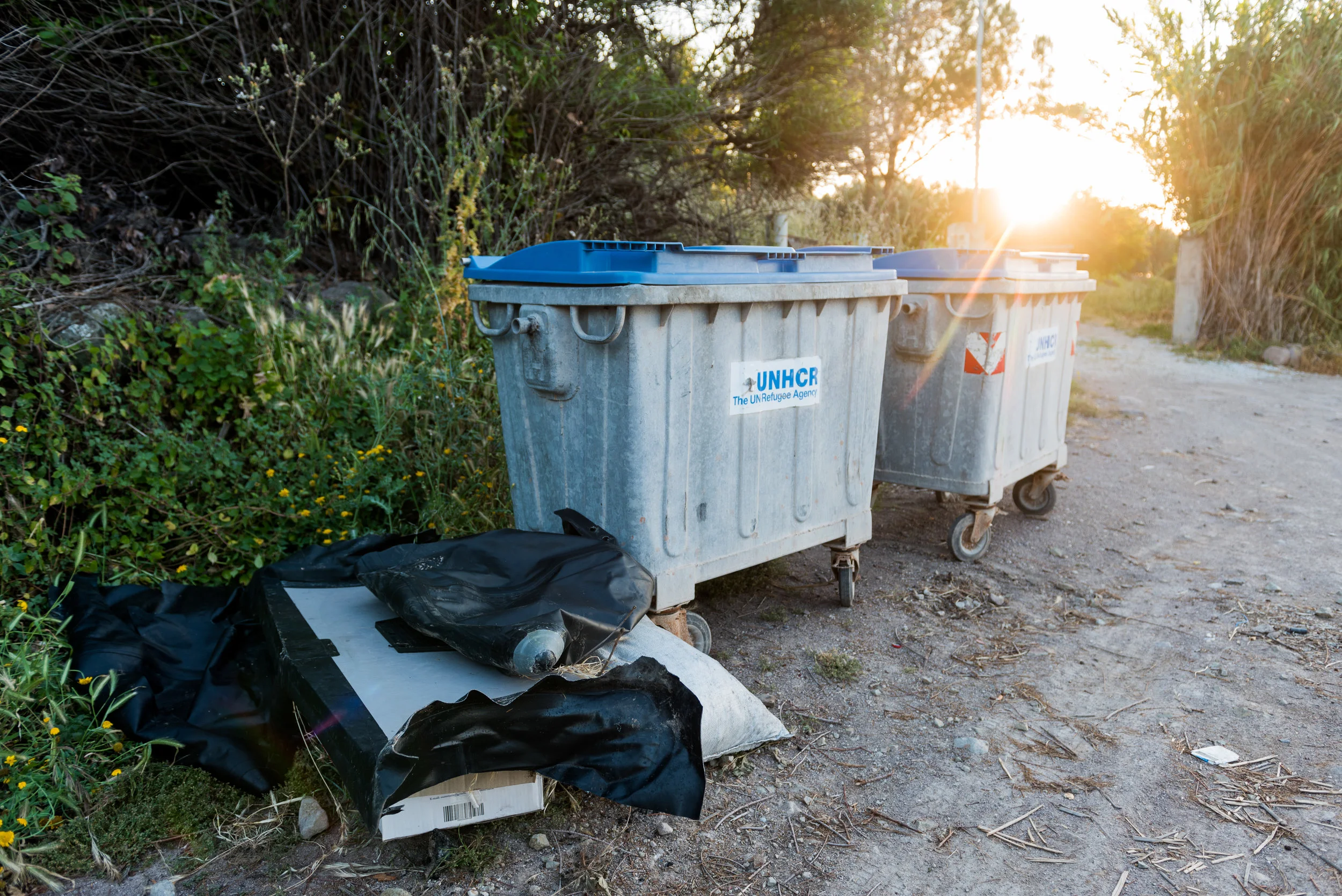 Parts of the cut-up dinghy sit next to two garbage bins just off of Lesvos' North shore.
