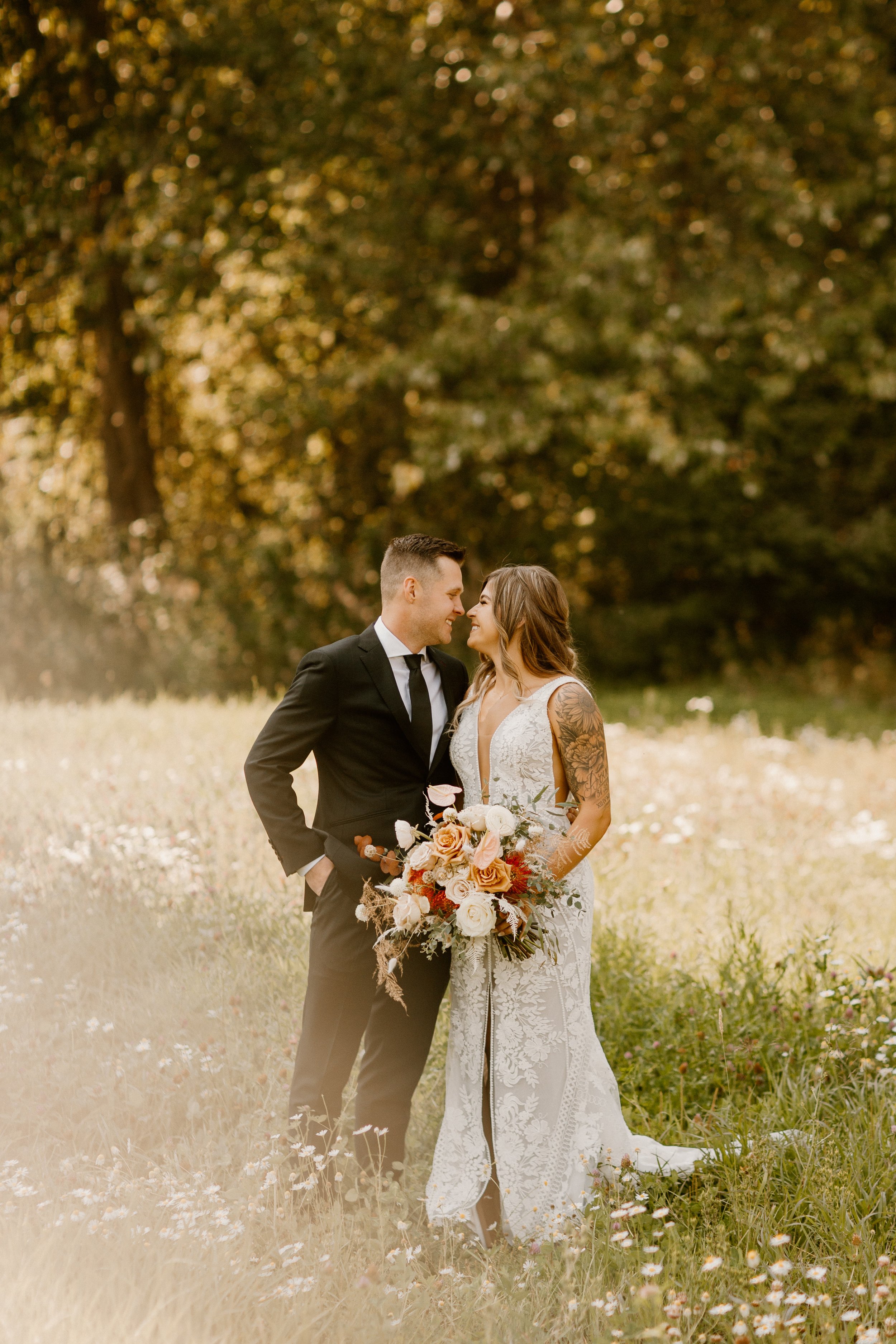 Bride and Groom nose to nose in a wildflower field in Leavenworth washington