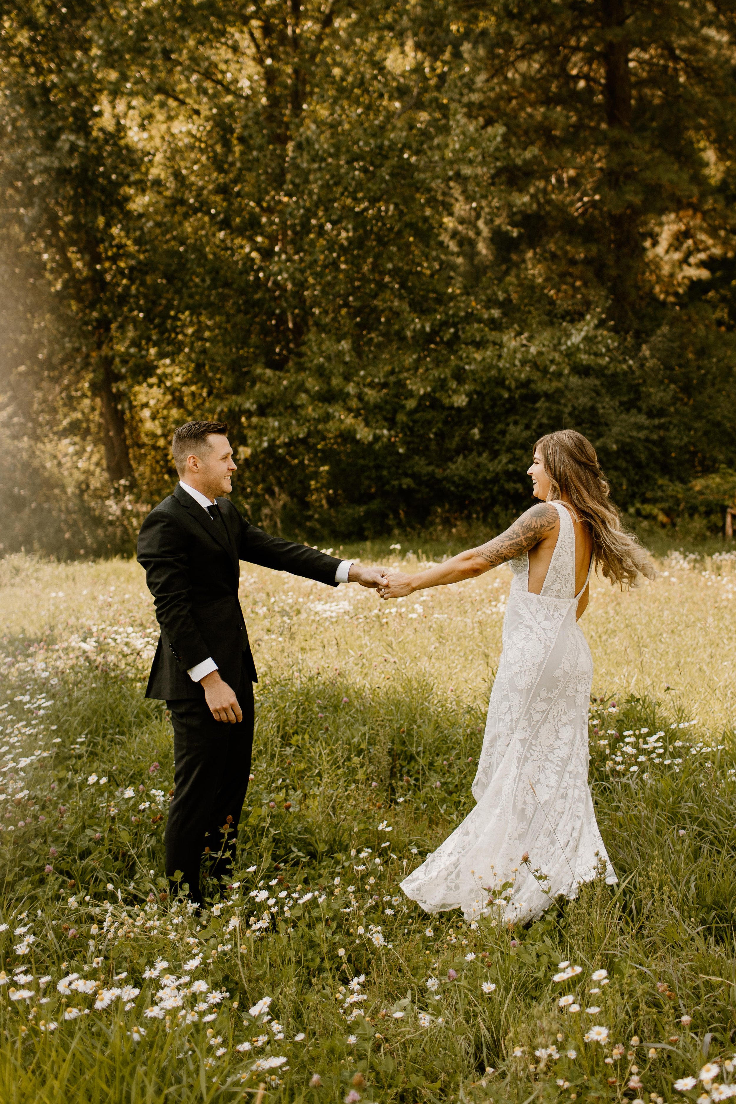 groom twirling bride in wildflower field in leavenworth washington