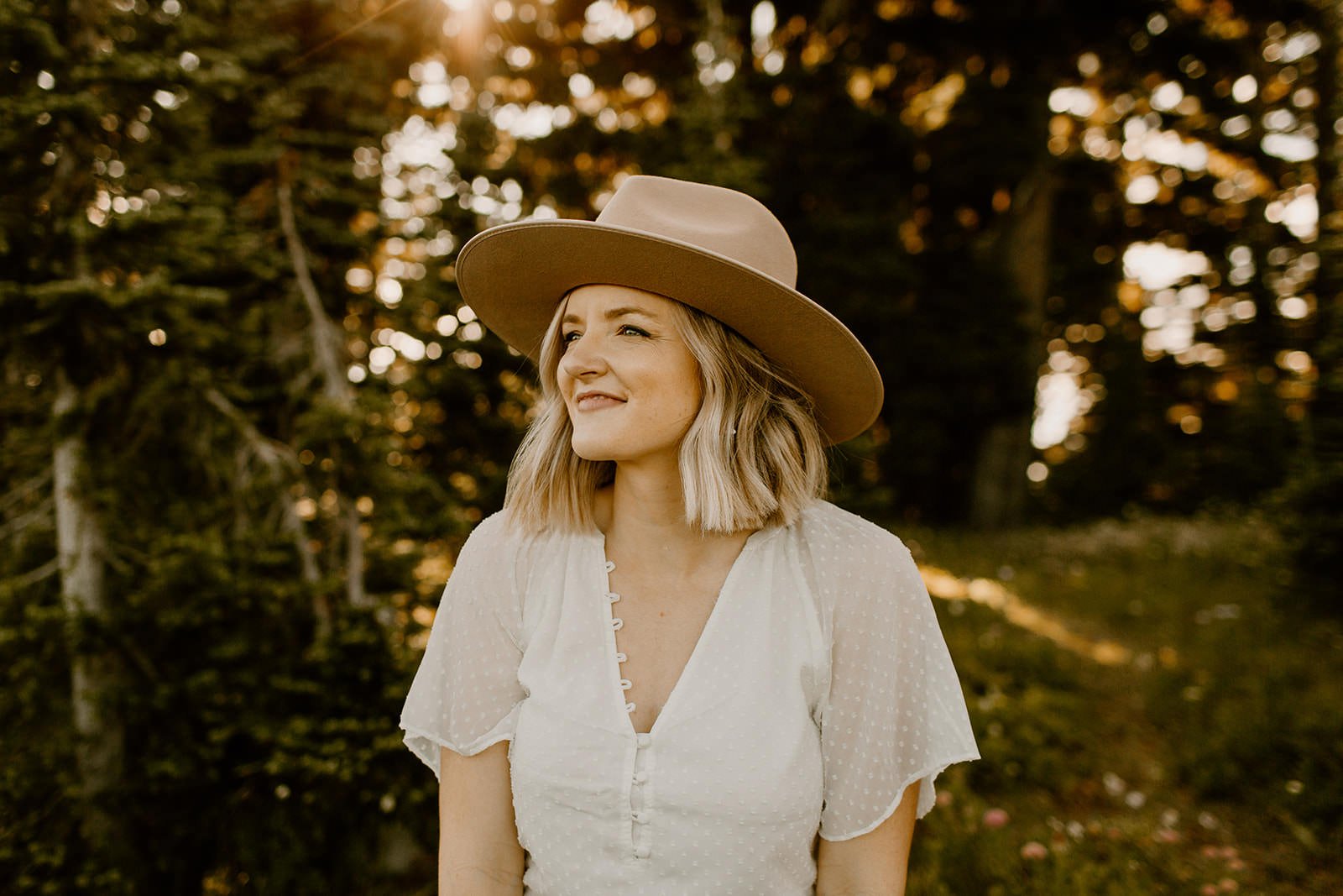 portrait of women wearing a flat brim boho styled hat