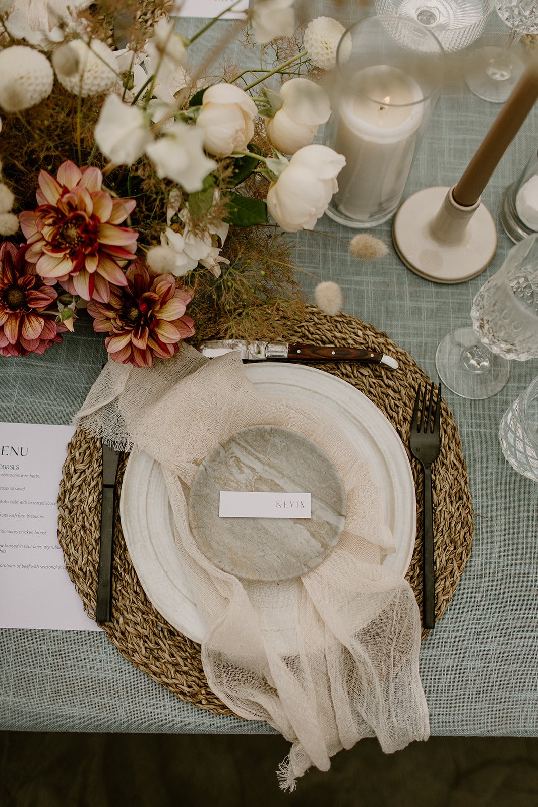 photo of the grooms dinner plate and the tablescape for their wedding reception on the beach