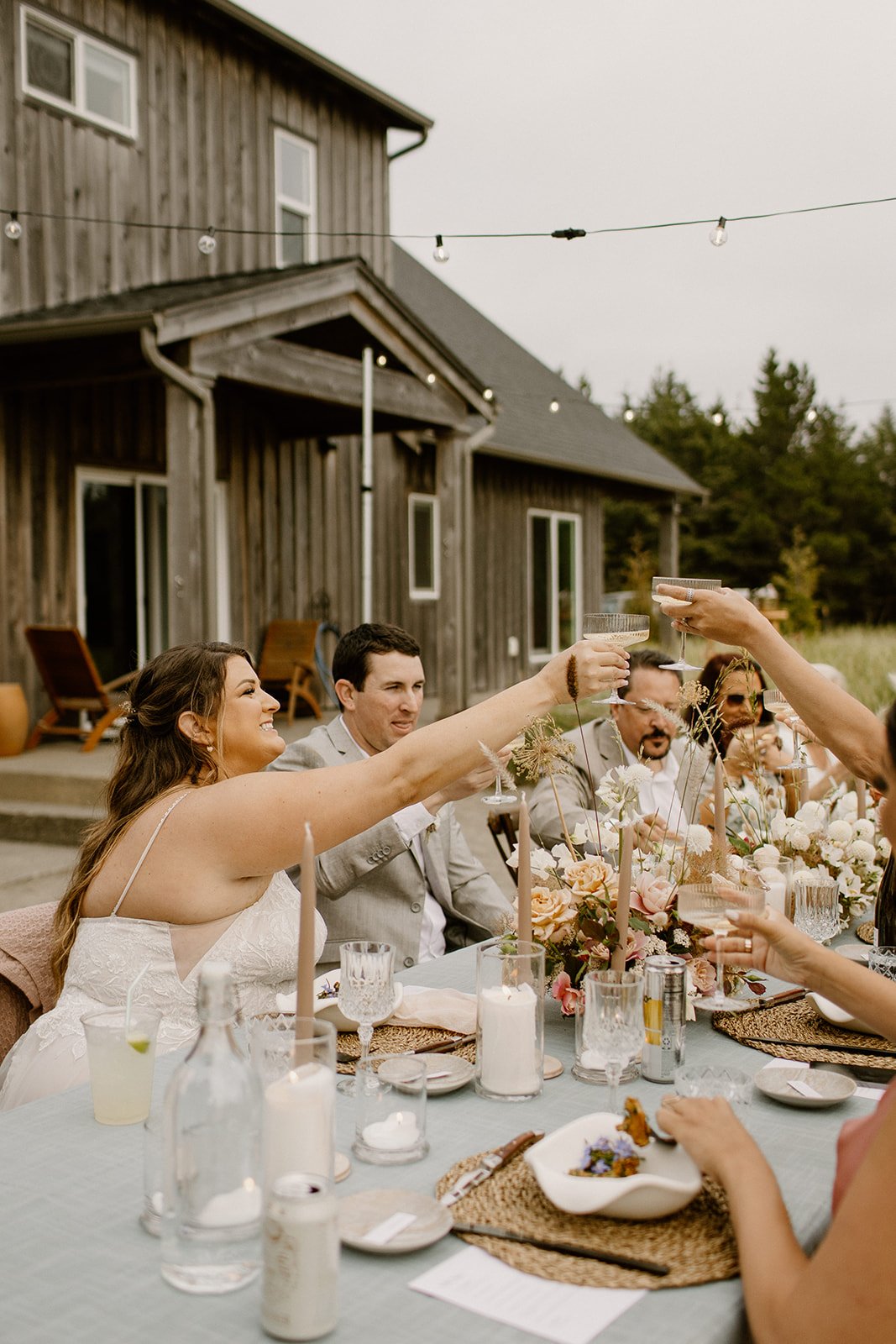 bride and groom toasting with their guests during their wedding dinner