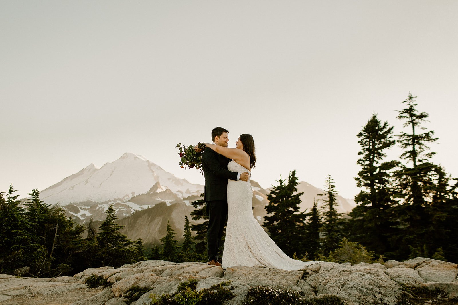 bride and groom hugging on a mountain ridge in the north cascades