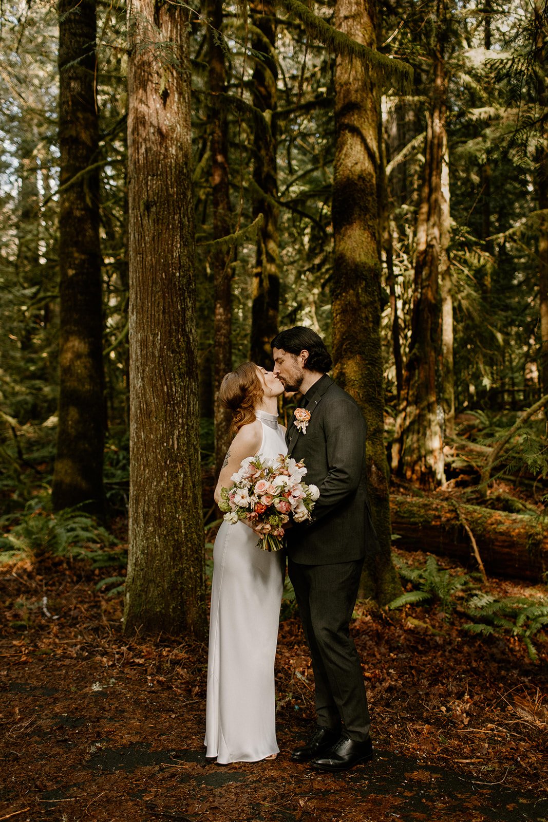 Bride and Groom kissing in an old growth forest in Olympic National Park