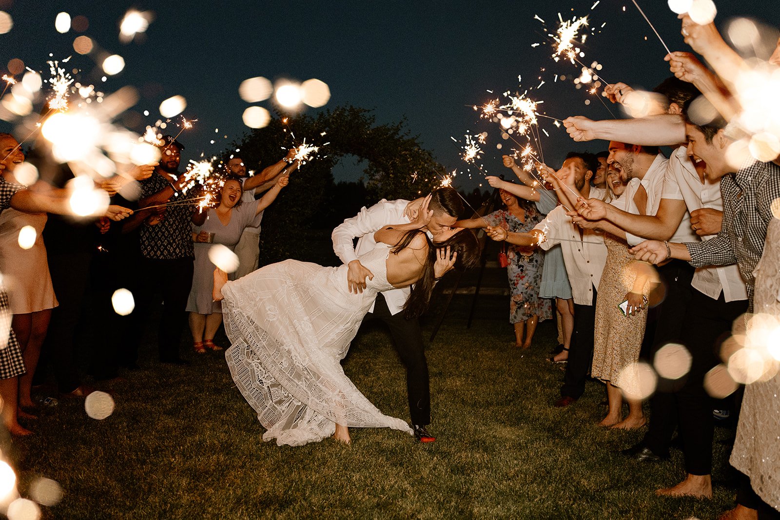 groom dipping the bride during their sparkler exit at the end of the night
