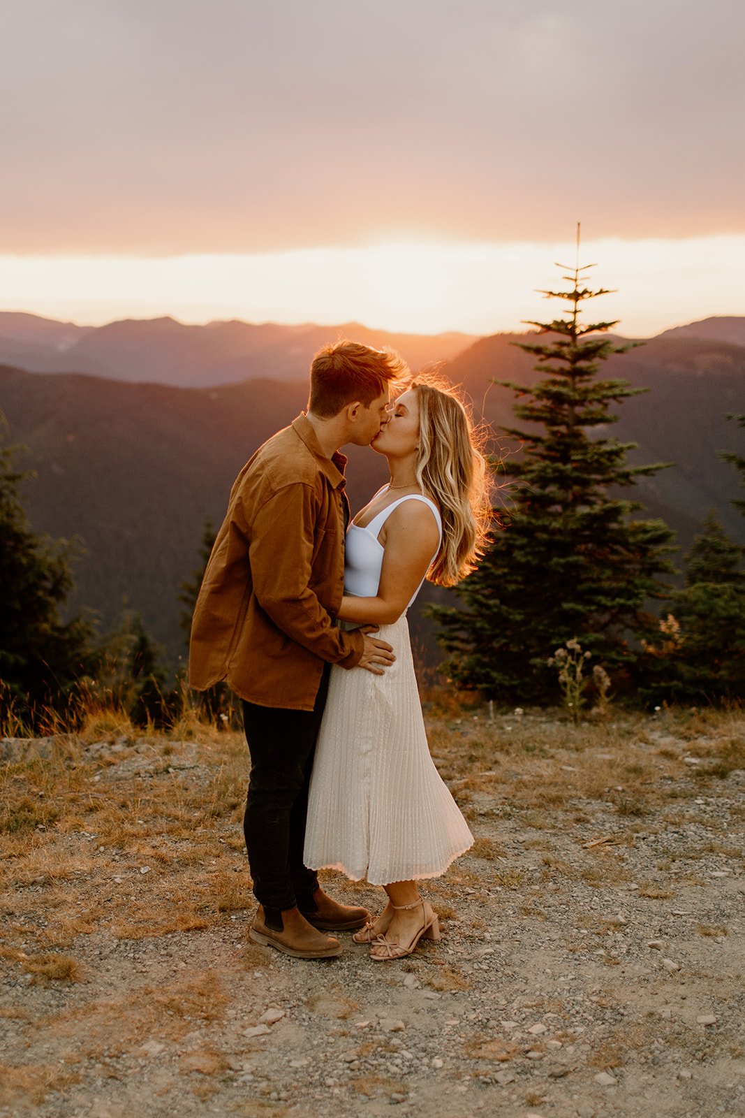 newly engaged couple kissing during sunset in mt rainier np