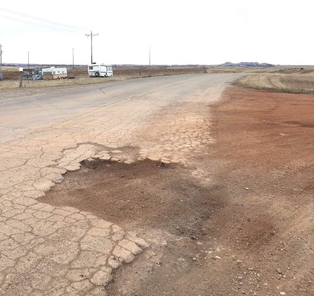  UOG development involves trucks that are often so heavy they have to apply for overweight load permits from the state and/or local municipalities. This picture illustrates the wear and tear that heavy traffic can have on roads.  