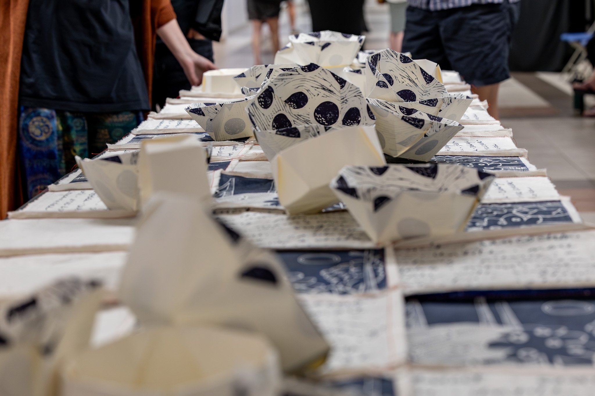 "Do you have everything you need?" is a print installation where linocut and screen printed images are sewn together and draped on a long table with linocut printed and origami folded bowls sit on top. The colour palette is warm white + Prussion blue