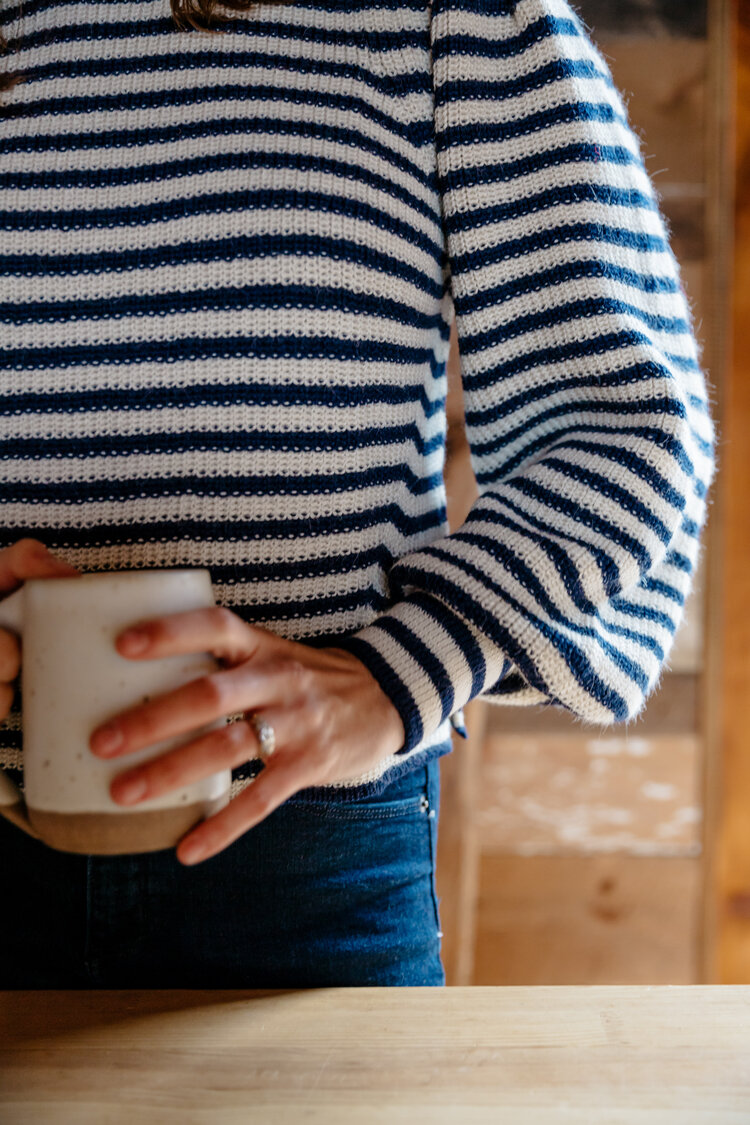 Dana wearing Fall 19 Mia sweater in stripe with Lail Design ceramic coffee mug