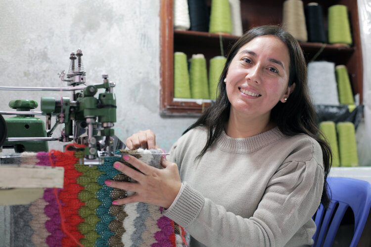Meet Olga - head&nbsp;artisan and owner of the workshop that makes and crafts our Fall 20 Tia sweater and Charlie Cardi.&nbsp; | Olga is&nbsp;at the linking machine...a&nbsp; machine that closes&nbsp;the garments seams&nbsp;as well as attaches the neck and cuff trims on to the sweater.