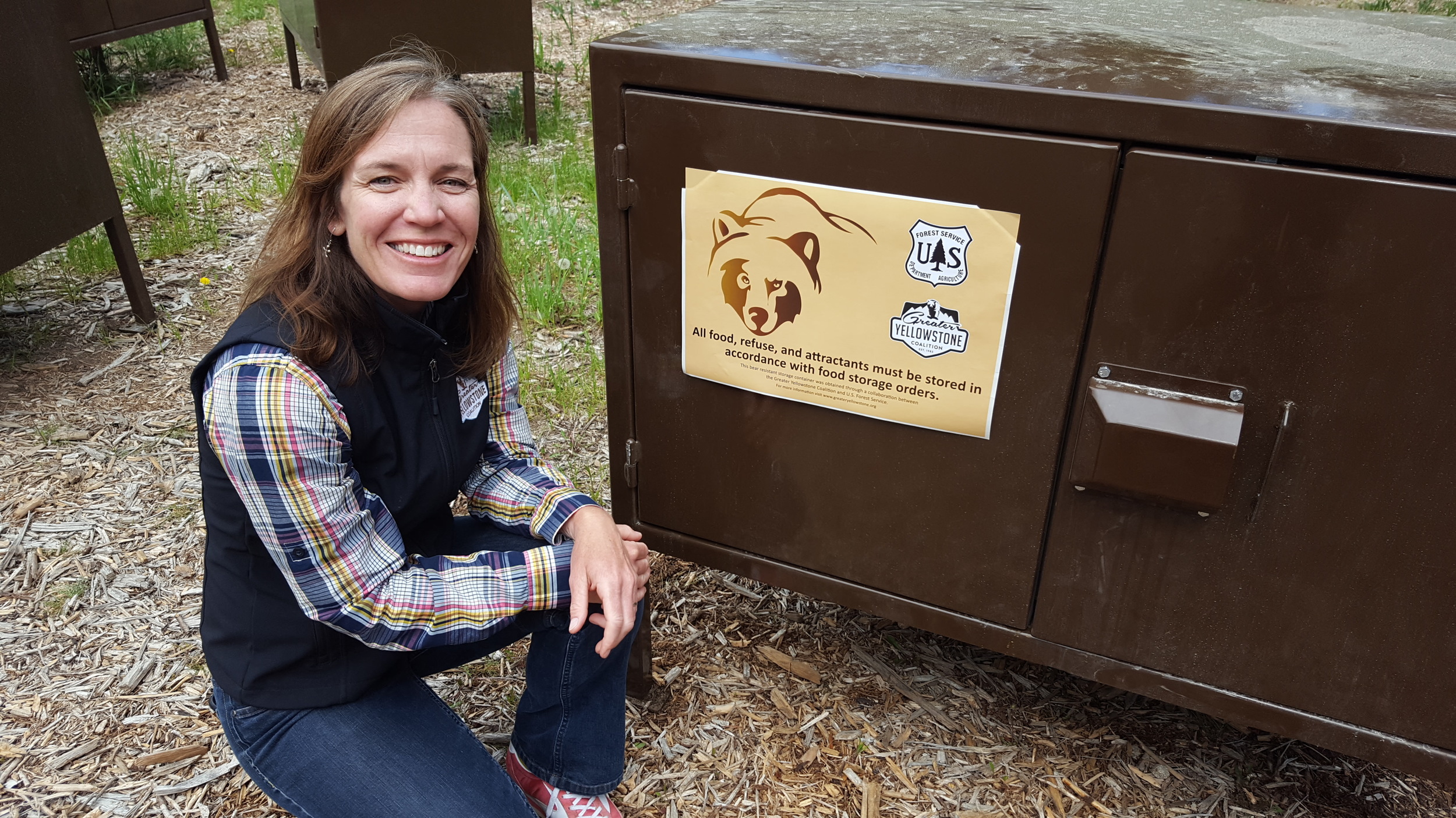 Greater Yellowstone Coalition’s Kathy Rinaldi with one of the bear boxes GYC and the Boy Scouts paid for to keep people safe and bears wild at Treasure Mountain Scout Camp. The 75-acre camp has attracted its share of bears in the past few years; GYC and the Scouts are working to end the conflict in Teton Canyon. (Photo Greater Yellowstone Coalition.)