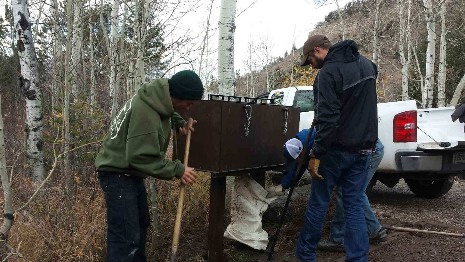 Keeping bears wild and people safe. GYC Wildlife Program Coordinator Chris Colligan (center, black jacket) works with the Bridger-Teton Wilderness Crew and the Teton Conservation District to install a bear box in a public campground southeast of Grand Teton National Park. (Photo GYC.)