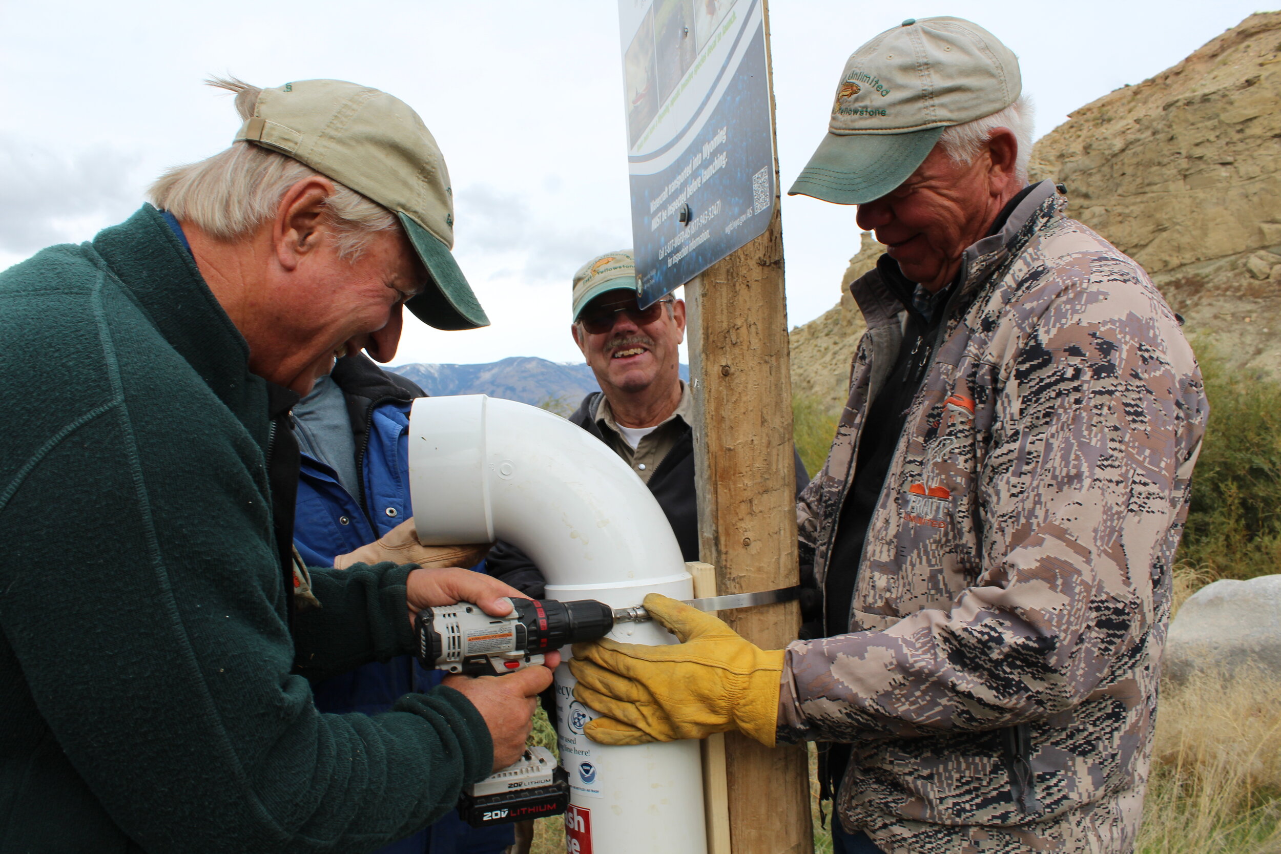 Volunteers install a microfilament recycle station, which allows for people to properly dispose of used fishing line. (Photo GYC/Emily Reed.)
