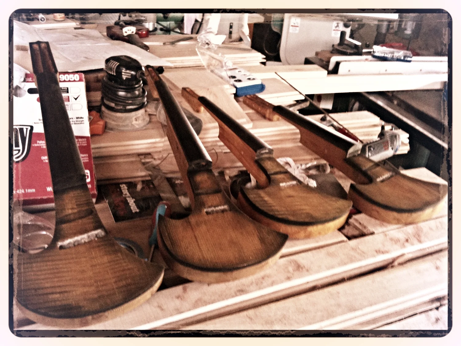 Four of Kyle's electric violins during the construction process
