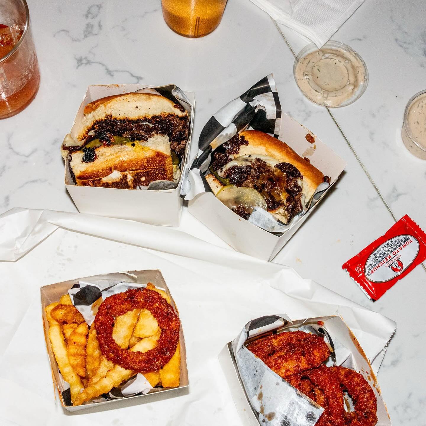 Frite Castle Sack at @easydoesitchicago @natties_and_patties Two smash sliders w/ LaPryor farms beef, cheese, griddled onions and hot mustard. Served with herb butter krinkle cut fries, sichuan bbq onion rings, black garlic buttermilk ranch, and ketc