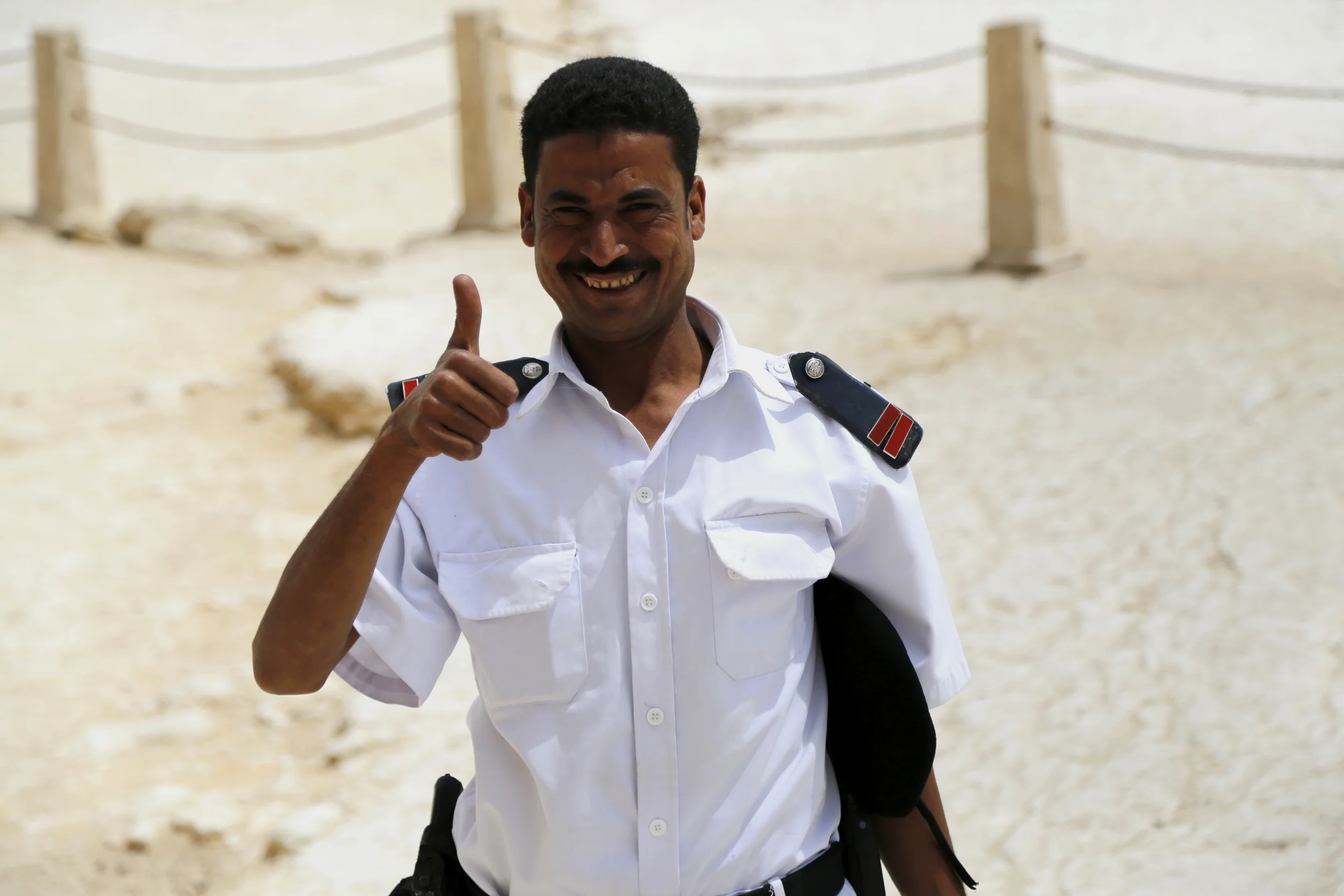  Egyptian policeman posing for a picture near The Sphinx of Giza.&nbsp;  (after the photo, he asked to be paid for posing, which he voluntarily offered in the first place.) 