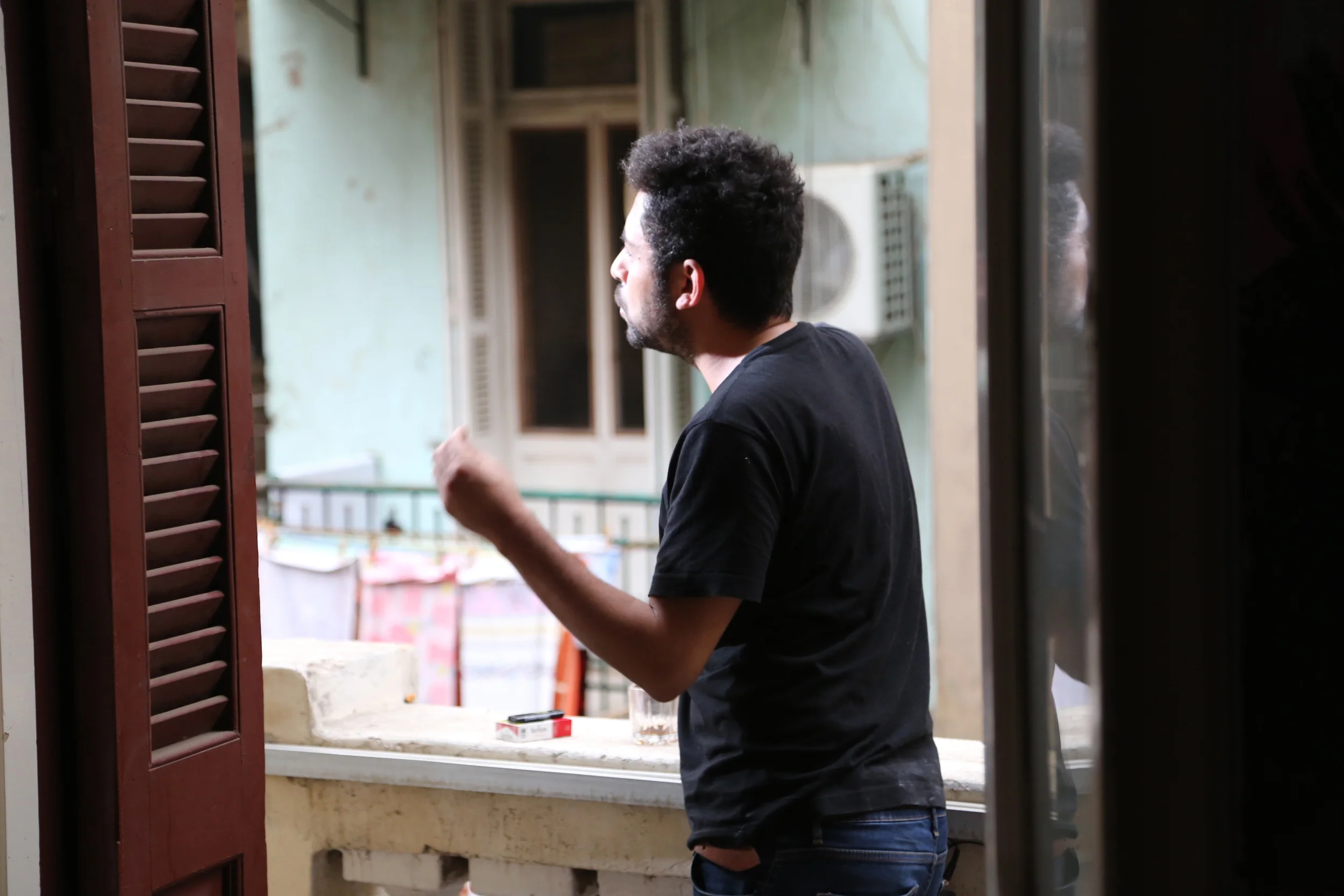  Artist&nbsp; Ammar Abo Bakr  on the balcony of his Cairo studio/apartment during his interview. 