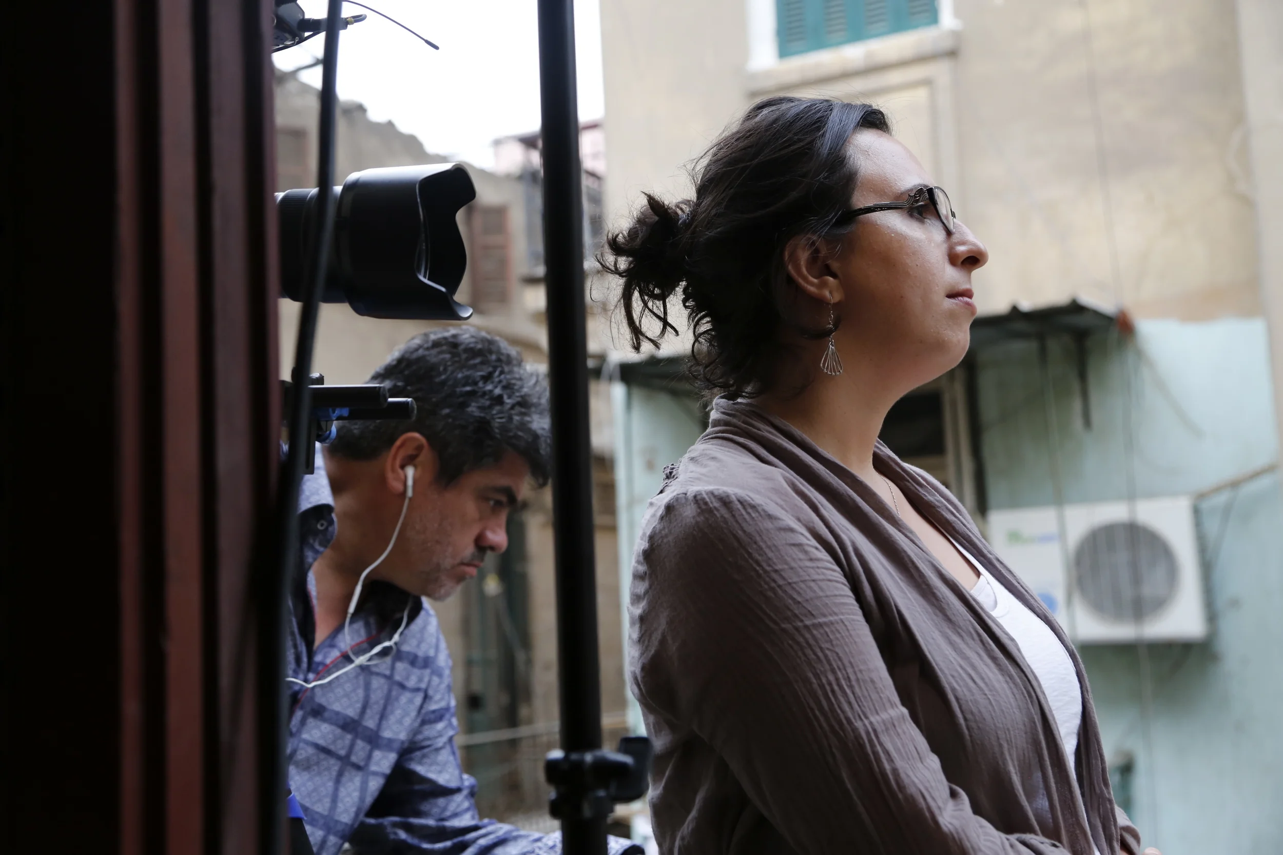  Co-director R acha Najdi , with cinematographer  Oscar Frasser , as she interviews artist  Ammar Abo Bakr  on the balcony of his Cairo studio/apartment. 